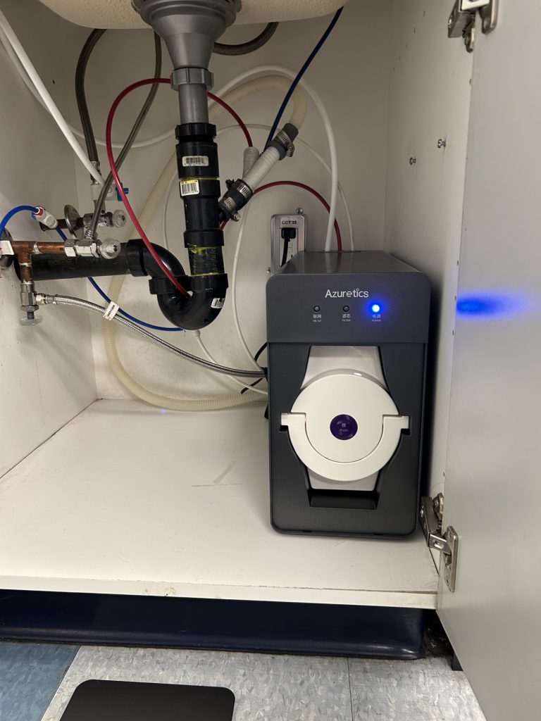 Azuretics 5 in 1 tankless reverse osmosis system model 85610 under a sink, with its single quick-turn combined cartridge and membrane element